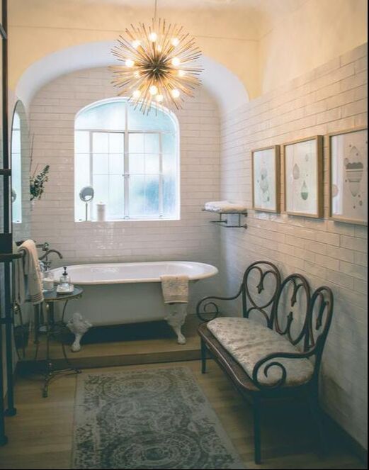 A bathroom with a clawfoot tub and ceramic tile on the wall in Akron Ohio